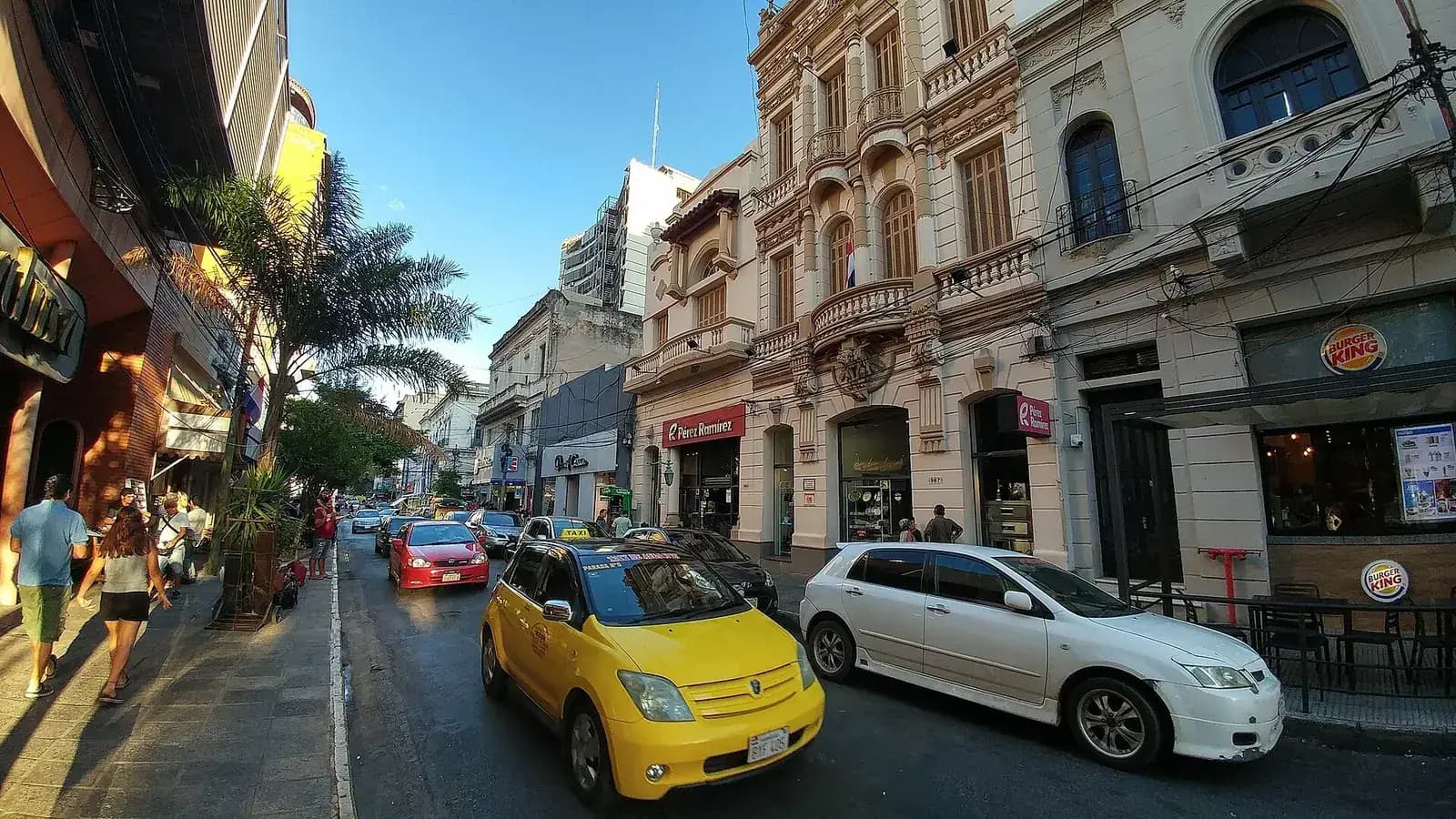 Calle Palma, rue commerçante du centre d'Asunción, avec taxi jaune, façades coloniales et commerces